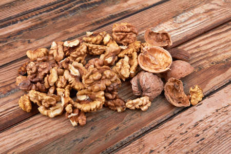 Pile of walnuts on a wooden surfaceの写真素材