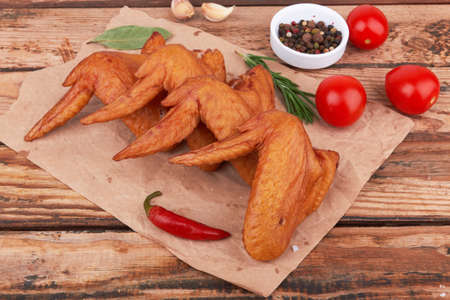 Smoked chicken wings on a wooden surfaceの写真素材