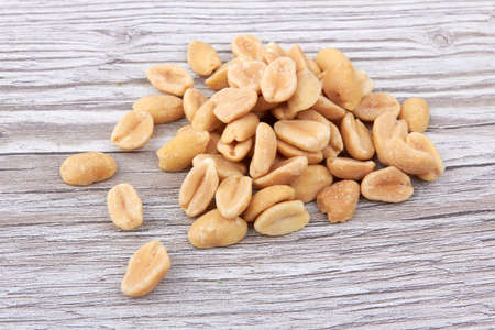 Salted peanuts on a wooden backgroundの写真素材
