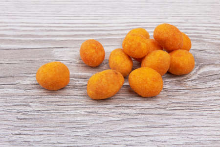 Bacon flavored peanuts on wooden backgroundの写真素材