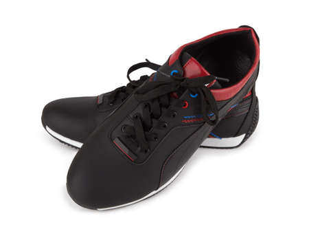 Black sneakers isolated on a white backgroundの写真素材