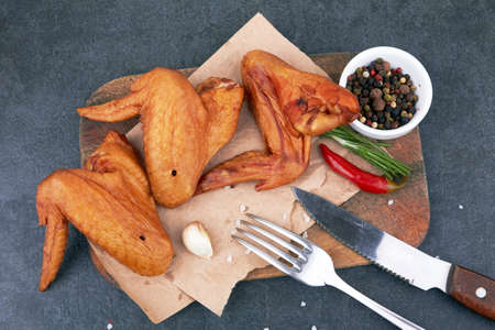 Smoked chicken wings on black backgroundの写真素材