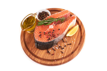 Salmon steak on board isolated on a white backgroundの写真素材