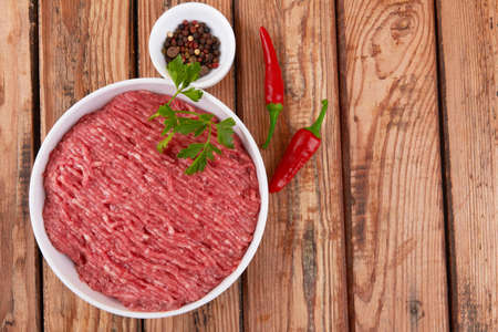 Fresh pork and beef minced meat on a wooden background.の写真素材