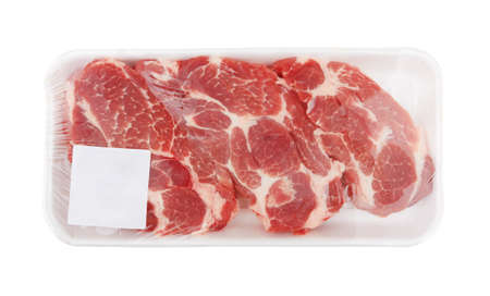Raw meat in package, isolated on white backgroundの写真素材