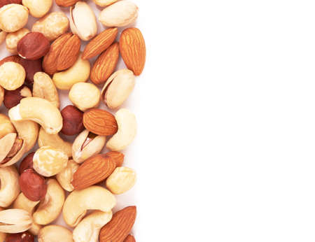 Heap of mixed nuts isolated on white backgroundの写真素材