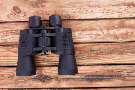 Black binoculars on a wooden surfaceの写真素材