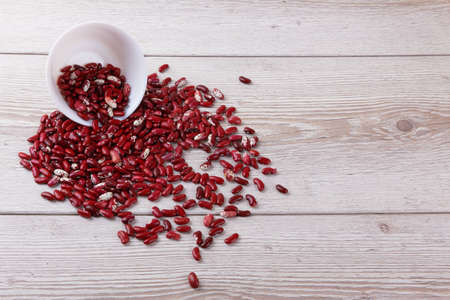 Red beans isolated on a wooden backgroundの写真素材