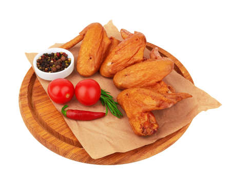 Smoked chicken wings on a cutting board on a white backgroundの写真素材