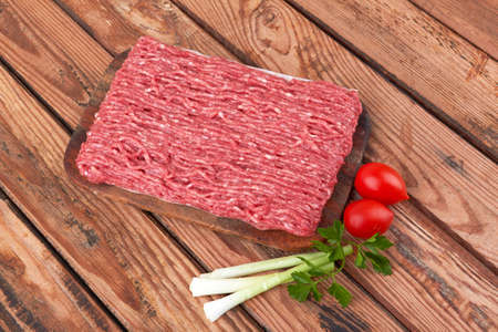 Fresh pork and beef minced meat on a wooden background.の写真素材