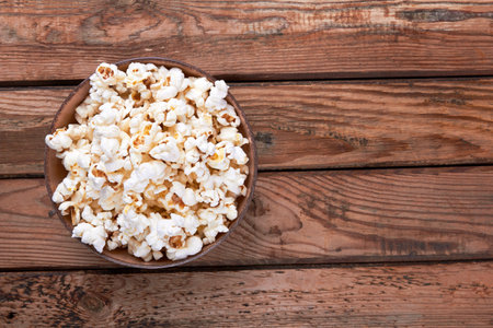 Popcorn in bowl food on wooden backgroundの写真素材