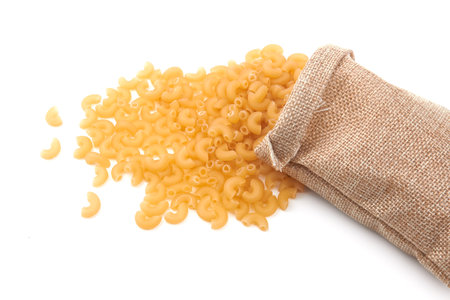 Elbow macaroni isolated on a white backgroundの写真素材