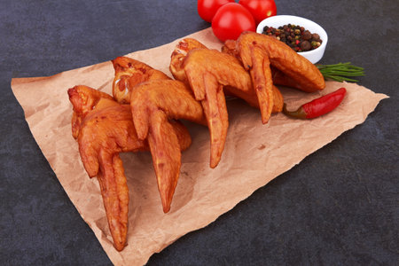 Smoked chicken wings on black backgroundの写真素材