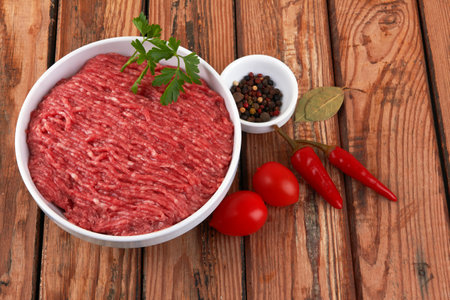 Fresh pork and beef minced meat on a wooden background.の写真素材