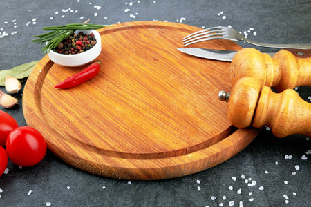 Cutting board on a stone black surfaceの写真素材