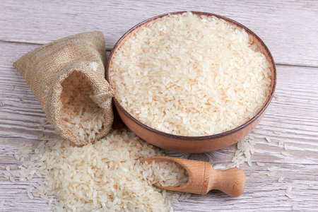 Rice in bowl on a wooden backgroundの写真素材