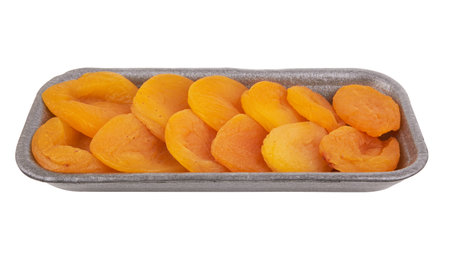 Dried apricots in box isolated on white backgroundの写真素材
