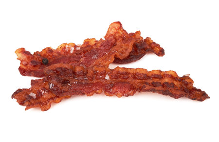 Cooked slices of bacon isolated on whiteの写真素材
