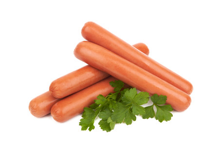 Fresh sausages with parsley leaves isolated on white backgroundの写真素材