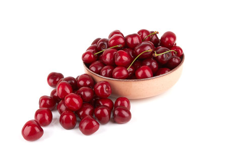 Red sweet cherry in bowl isolated on white backgroundの写真素材