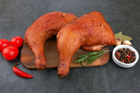 Smoked chicken thighs on a black stone surfaceの写真素材