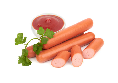 Fresh sausages with parsley leaves isolated on white backgroundの写真素材