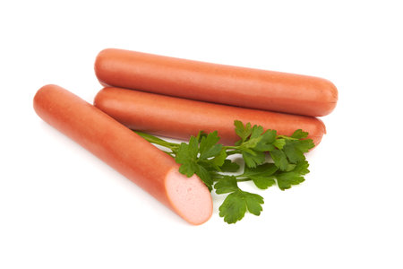 Fresh sausages with parsley leaves isolated on white backgroundの写真素材