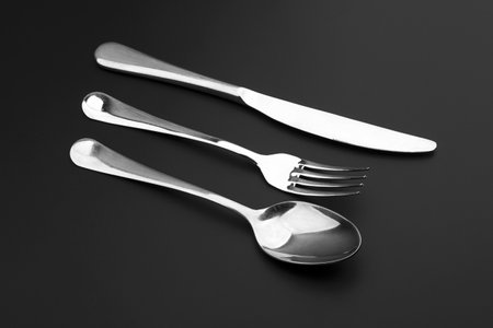 Fork knife and spoon on black backgroundの写真素材