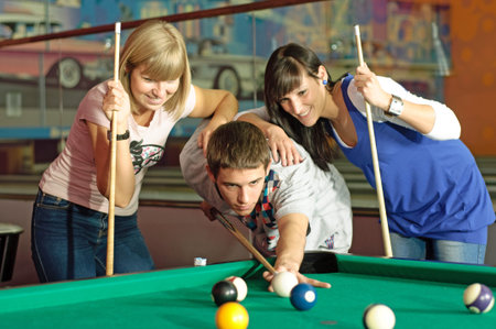 friends playing pool.