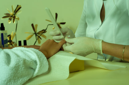 Photo of woman hands during manicureの写真素材