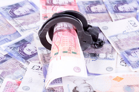 photo showing money with handcuffsの写真素材