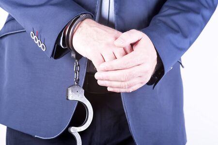 a picture of a businessman locked in handcuffsの写真素材