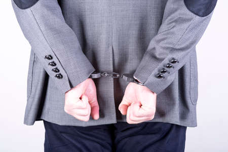 a picture of a businessman locked in handcuffsの写真素材