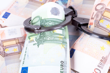 photo showing money with handcuffs