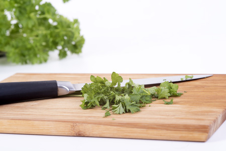 a photo of parsley on a chopping board cookeryの写真素材
