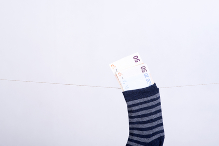 photo showing the savings in euros hidden in a sockの写真素材