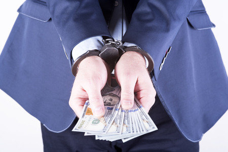 photo showing money with handcuffsの写真素材