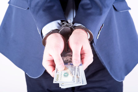 photo showing money with handcuffs