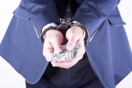 photo showing money with handcuffsの写真素材