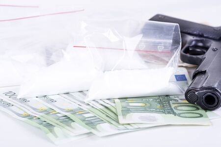 photo of the drugs, cocaine , money and gunの写真素材