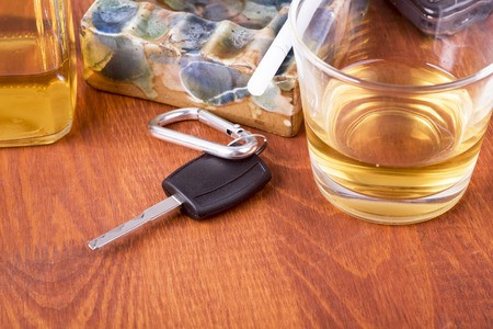 a photo of alcohol, car keys which equals tragedy on the roadの写真素材