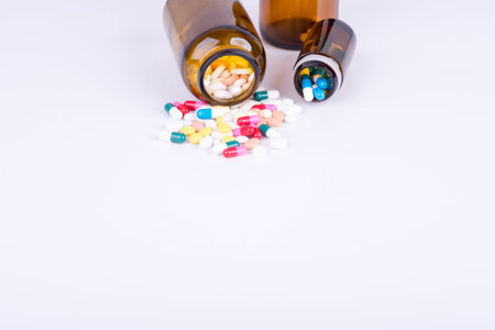 Colored pills and tablets on white backgroundの写真素材