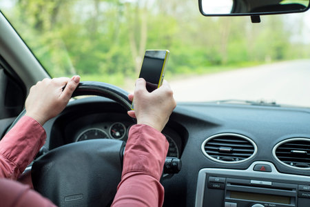 image depicting a woman riding in a car and talking on the phoneの写真素材