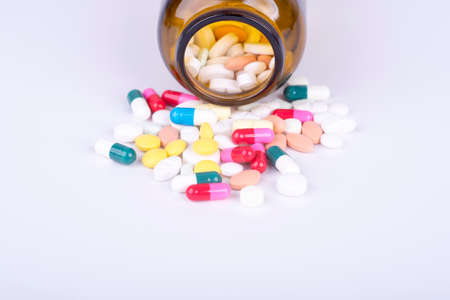 Colored pills and tablets on white backgroundの写真素材