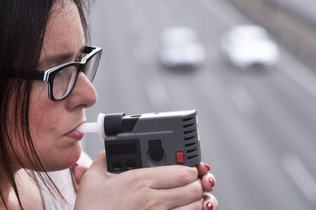 woman investigating on alkom alcohol levelの写真素材