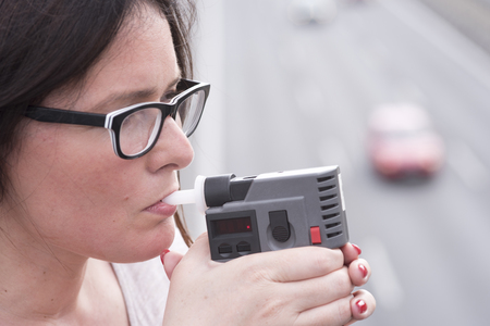woman investigating on alkom alcohol levelの写真素材