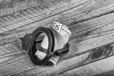 Handcuffs and euro billsの写真素材