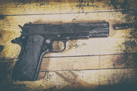 solitary gun  on wooden backgroundの写真素材
