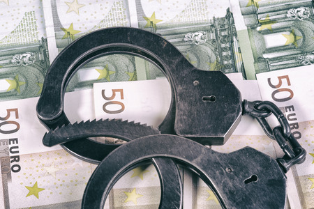 Handcuffs and euro billsの写真素材