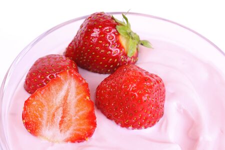 Fresh strawberries in fruit yogurt isolated on white backgroundの写真素材